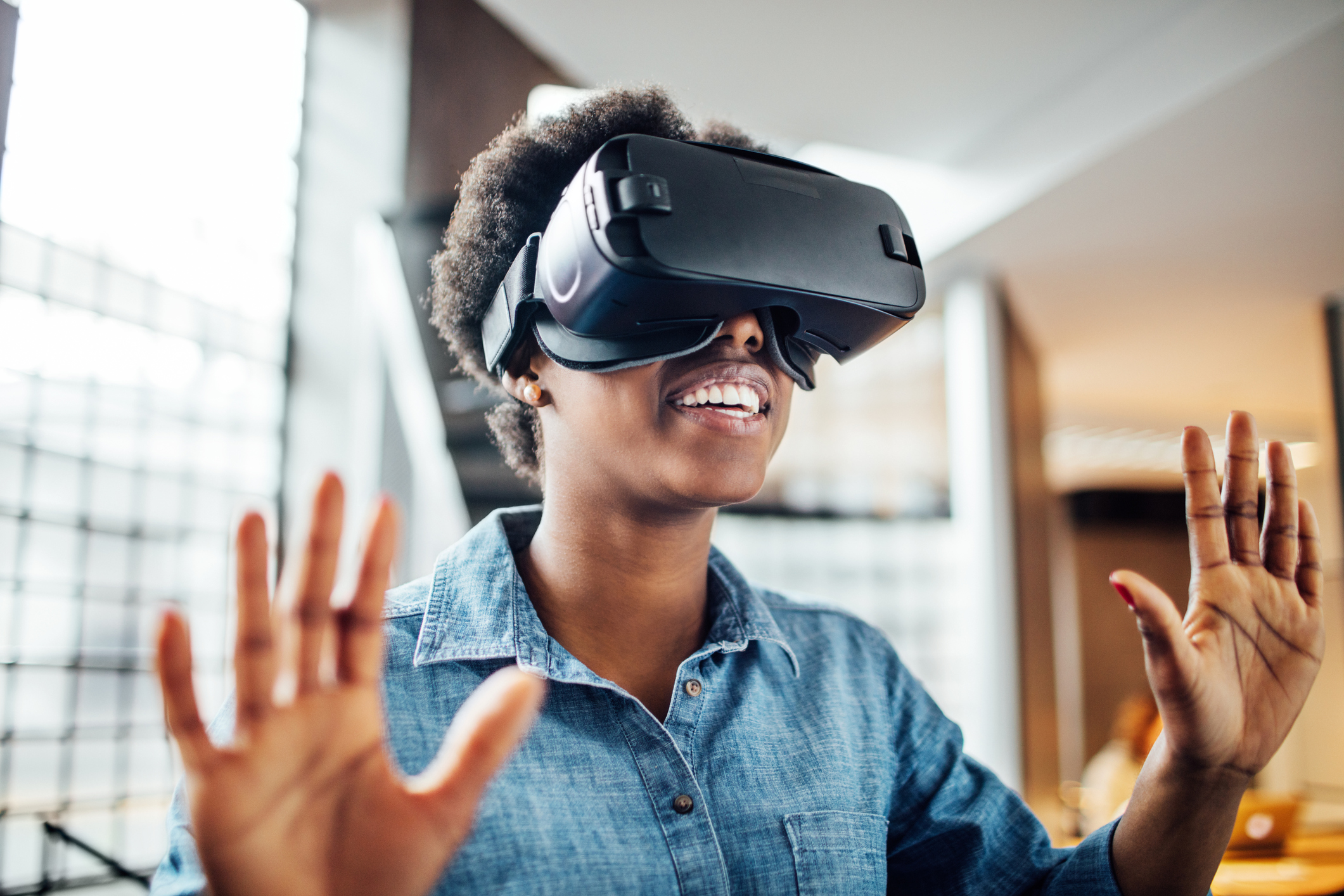 Young female at startup using VR goggles